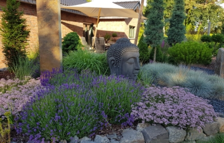 Beet mit Blumen und Gartenaccesoirs